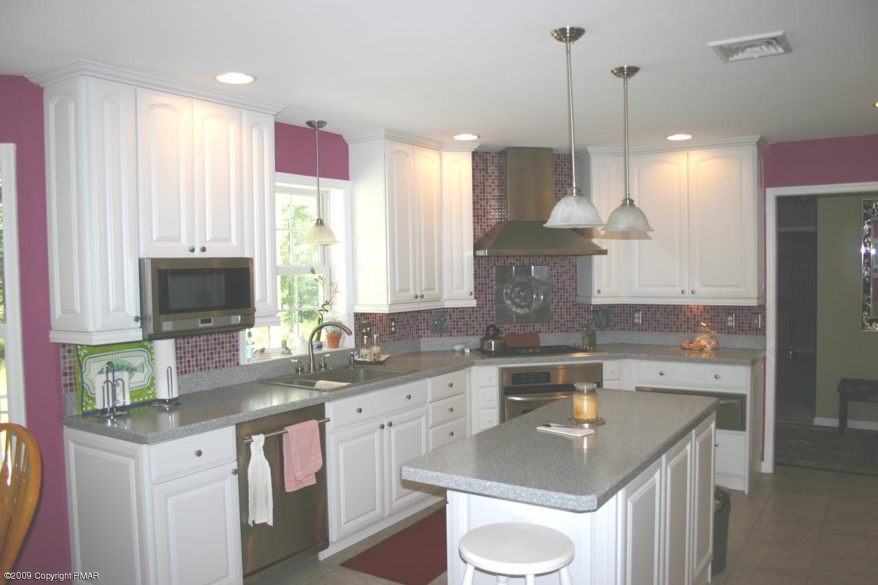 2189 Spruce Cabin Road Cresco, PA 18326 - Photo 3 of 13 a kitchen with a sink stove and cabinets