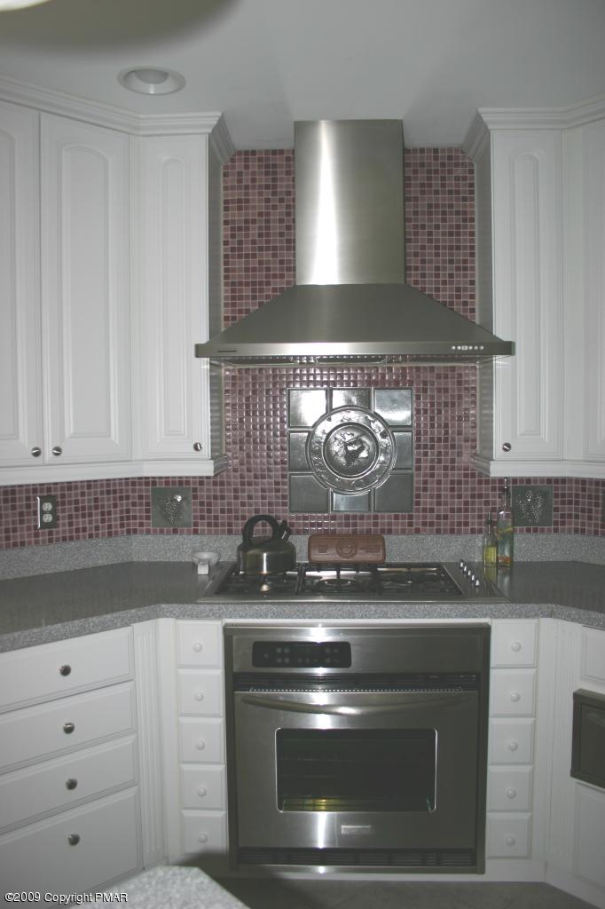 2189 Spruce Cabin Road Cresco, PA 18326 - Photo 8 of 13 a stove top oven sitting inside of a kitchen