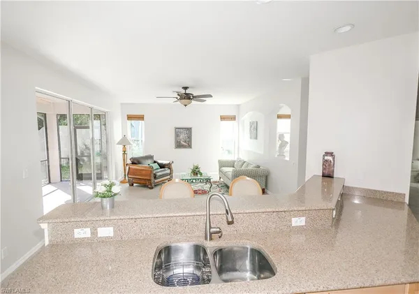 a kitchen with kitchen island a sink and a mirror