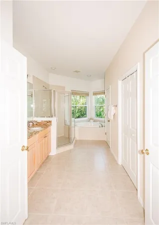 a view of a kitchen with a sink and dishwasher with wooden floor