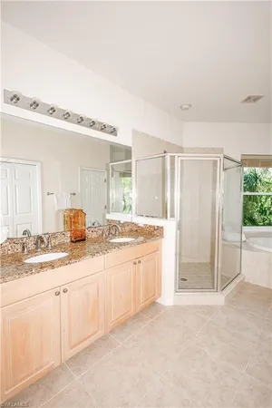 a large bathroom with a granite countertop sink and a mirror