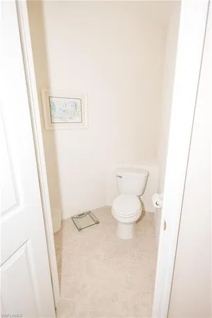a white toilet sitting next to a shower