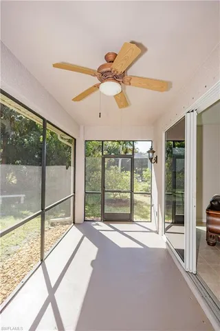 a view of a room with window and a ceiling fan