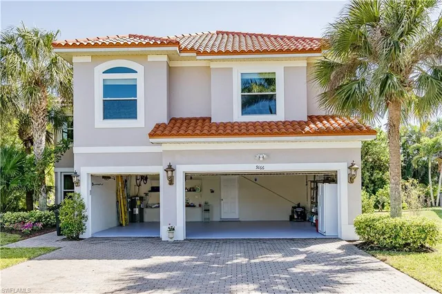 a view of a house with potted plants
