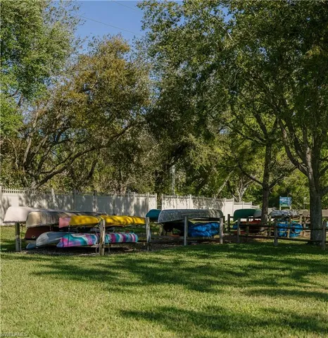 a childrens park with lots of trees and umbrellas