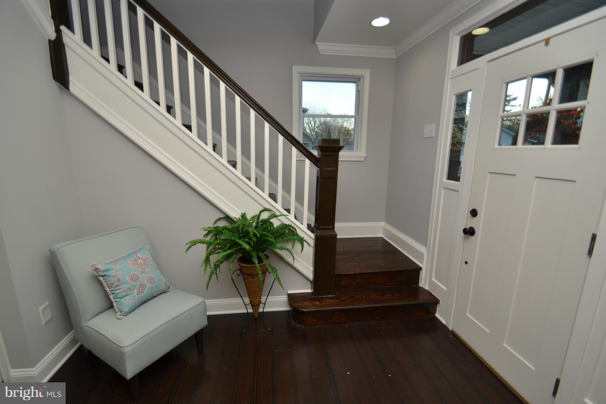 3810 Ridgecroft Road Baltimore, MD 21206 - Photo 14 of 30 a hallway with wooden floor stairs and a potted plant