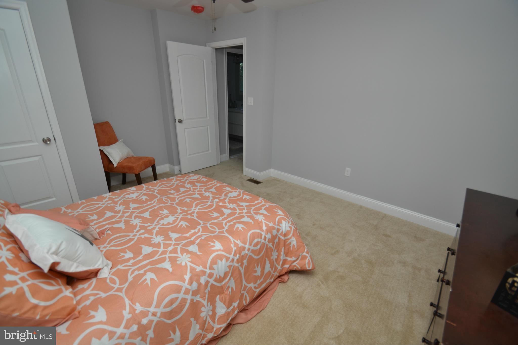 3810 Ridgecroft Road Baltimore, MD 21206 - Photo 17 of 30 a bedroom with a bed and a flat screen tv