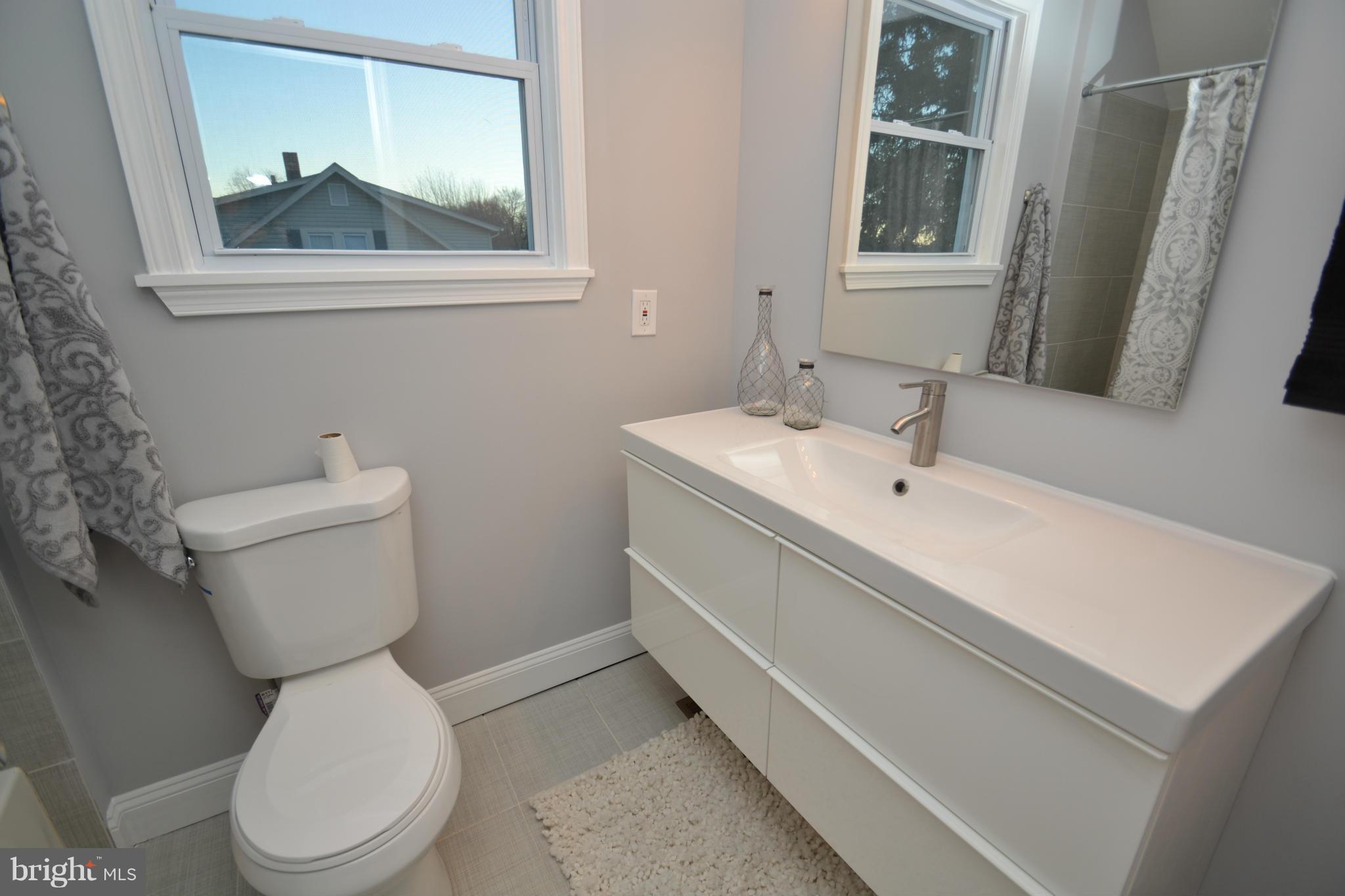 3810 Ridgecroft Road Baltimore, MD 21206 - Photo 18 of 30 a white toilet sitting next to a bathroom sink