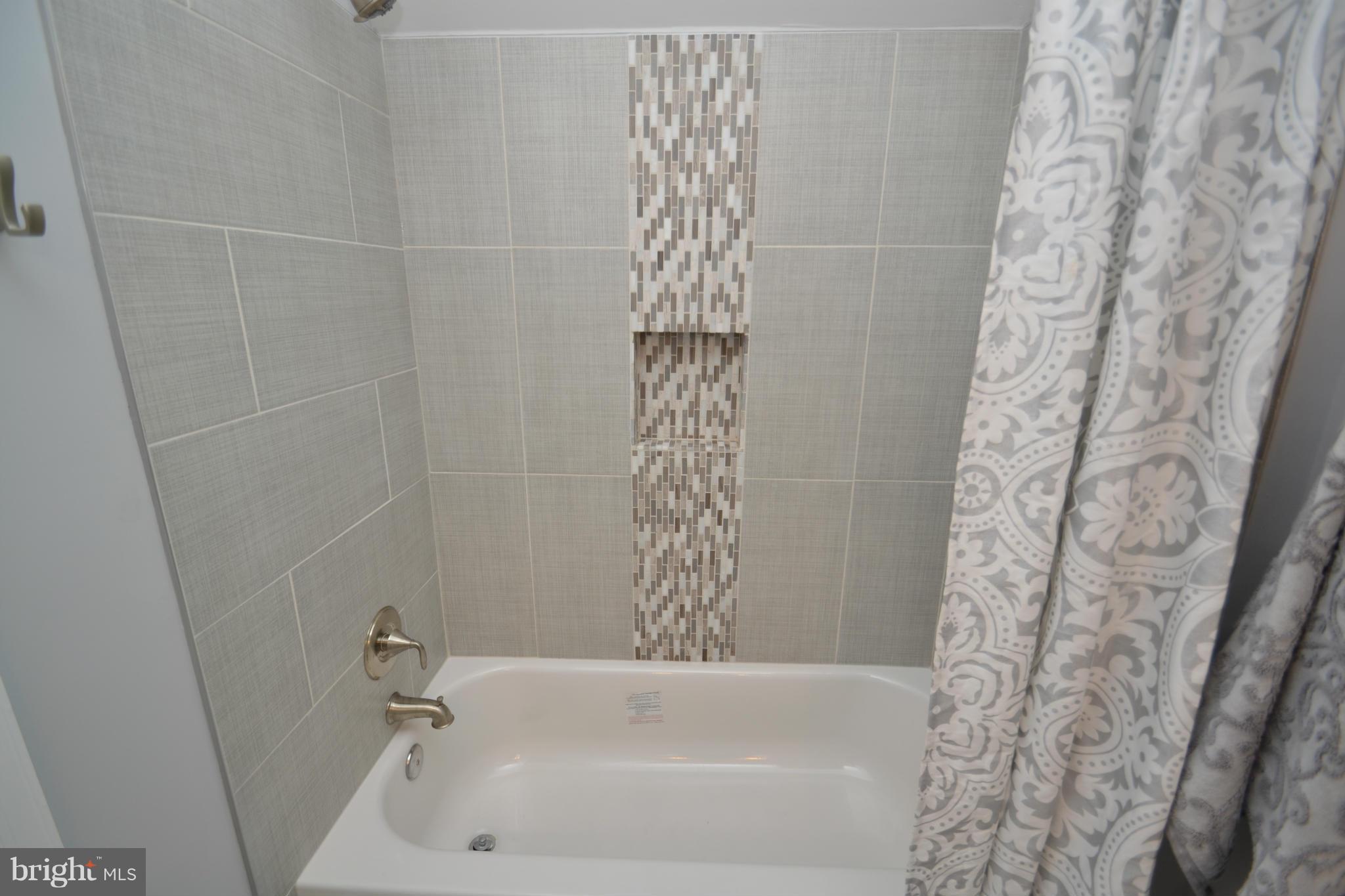 3810 Ridgecroft Road Baltimore, MD 21206 - Photo 19 of 30 a bathroom with a bathtub and shower