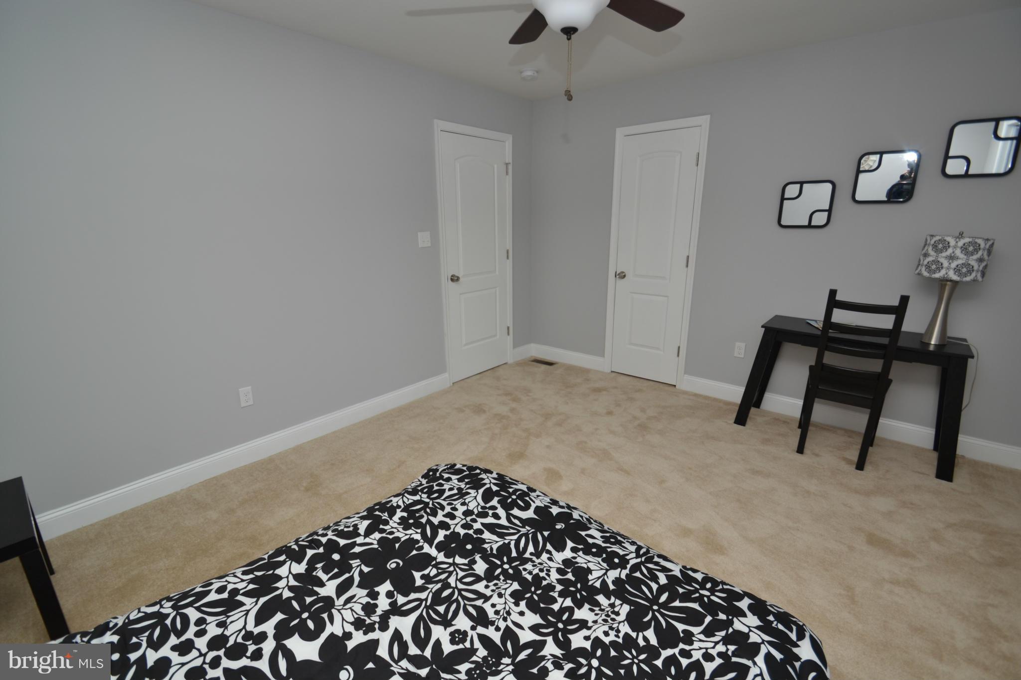 3810 Ridgecroft Road Baltimore, MD 21206 - Photo 21 of 30 a bedroom with a bed and a chair