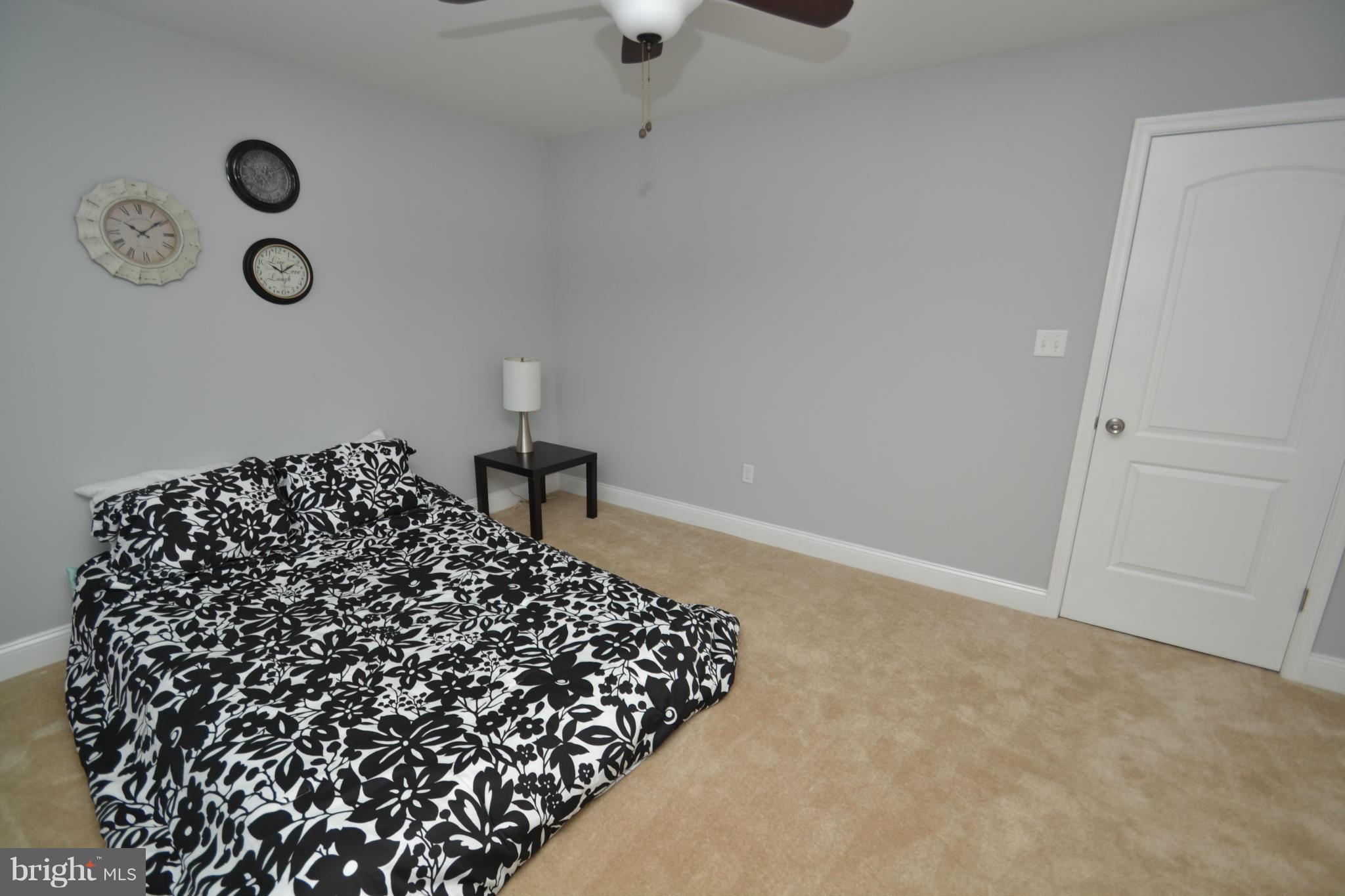 3810 Ridgecroft Road Baltimore, MD 21206 - Photo 22 of 30 a bed room with a bed and a chandelier
