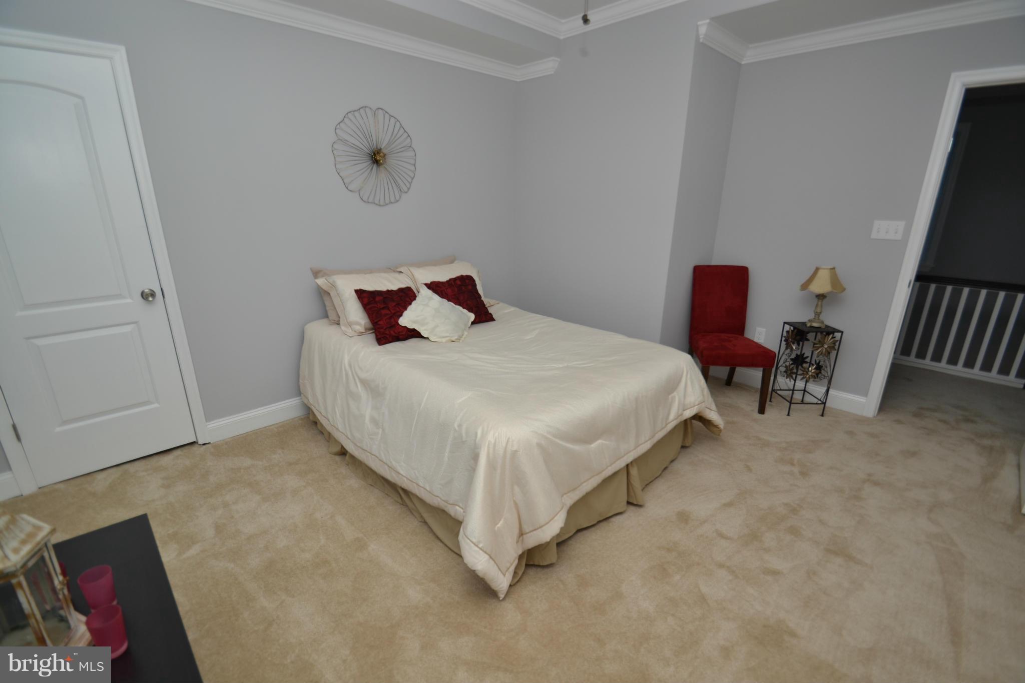3810 Ridgecroft Road Baltimore, MD 21206 - Photo 24 of 30 a bedroom with a bed and a chair