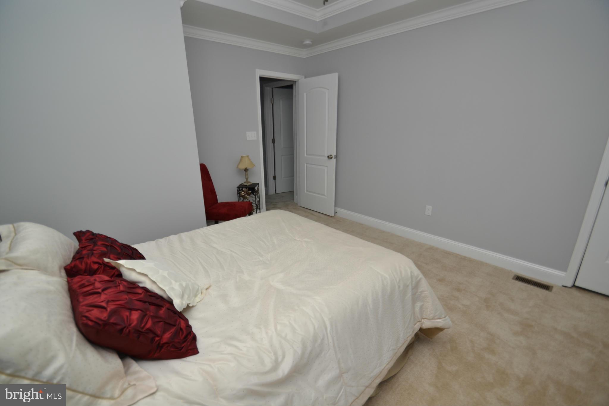 3810 Ridgecroft Road Baltimore, MD 21206 - Photo 25 of 30 a bedroom with a bed and a white wall