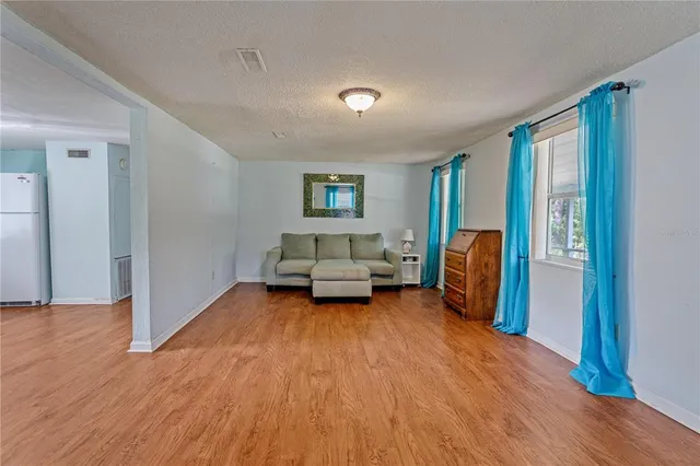 a bedroom with a bed and a wooden floor