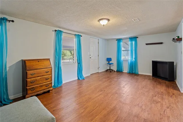 a view of a bedroom with furniture and closet