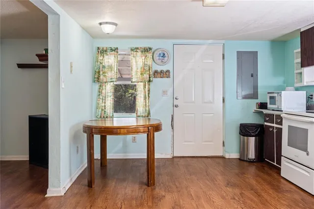 a view of kitchen with furniture and wooden floor