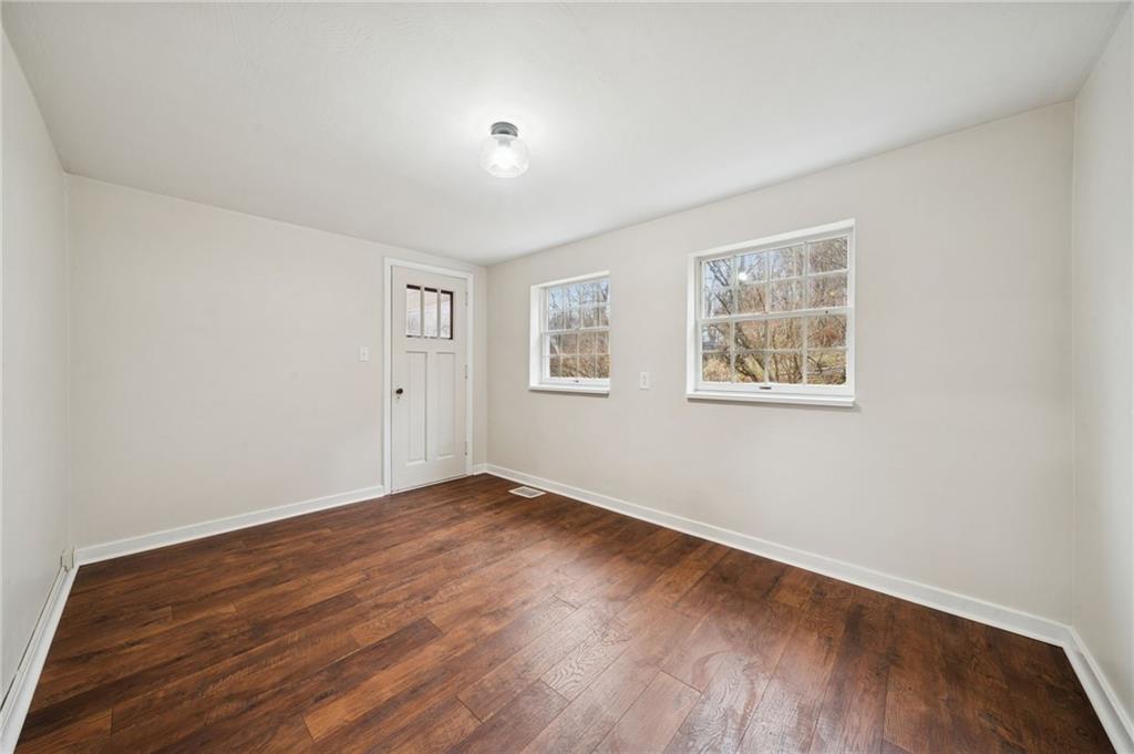 601 Milltown Road New Kensington, PA 15068 - Photo 21 of 36 a view of an empty room with wooden floor and a window