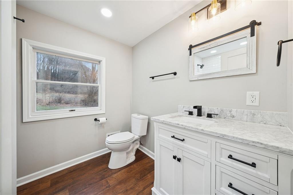 601 Milltown Road New Kensington, PA 15068 - Photo 22 of 36 a bathroom with a granite countertop toilet a sink and a mirror