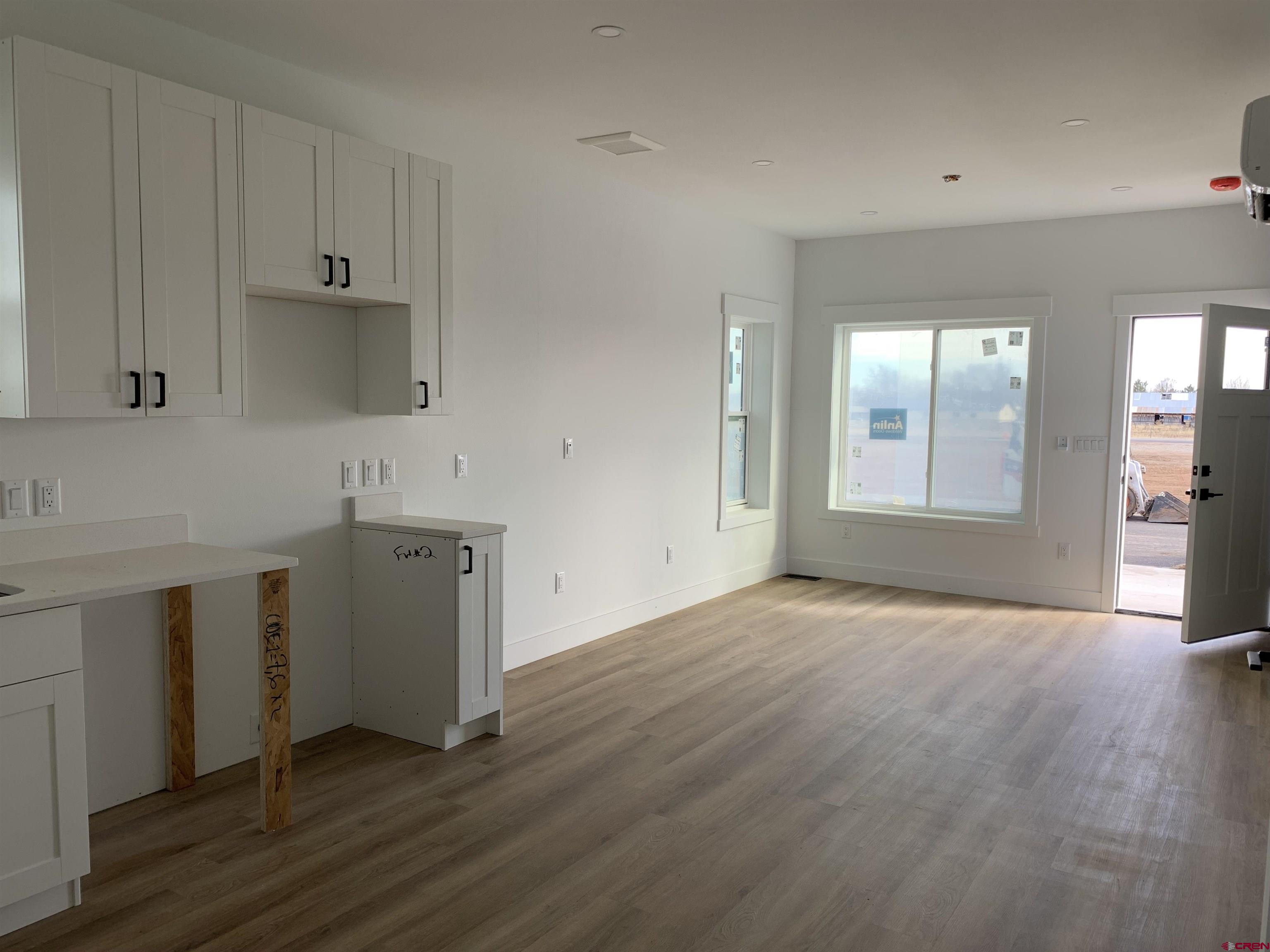 210 Manzano Circle Ignacio, CO 81137 - Photo 4 of 9 a view of a kitchen with wooden floor and a sink