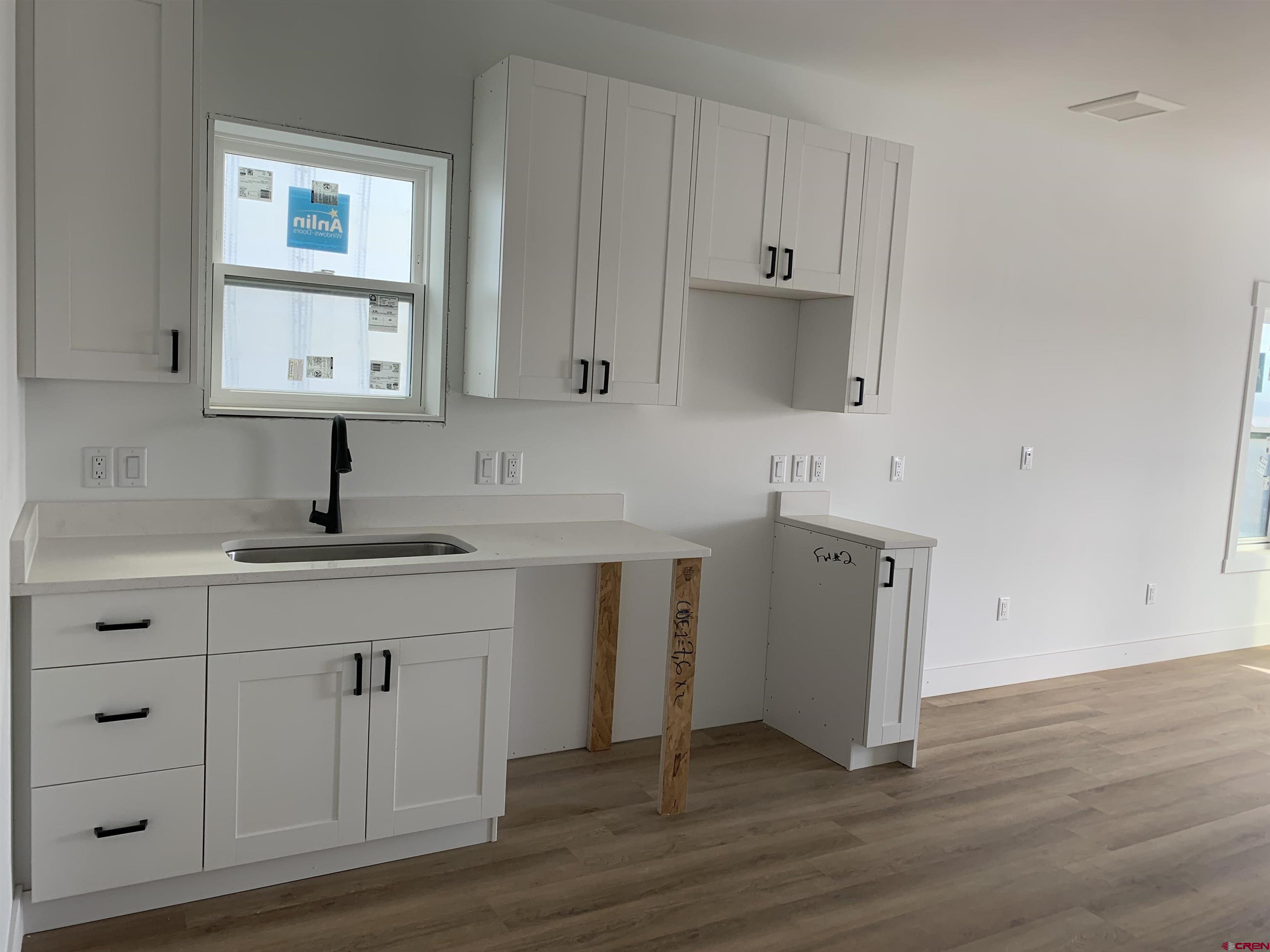 210 Manzano Circle Ignacio, CO 81137 - Photo 5 of 9 a kitchen with a sink cabinets and wooden floor
