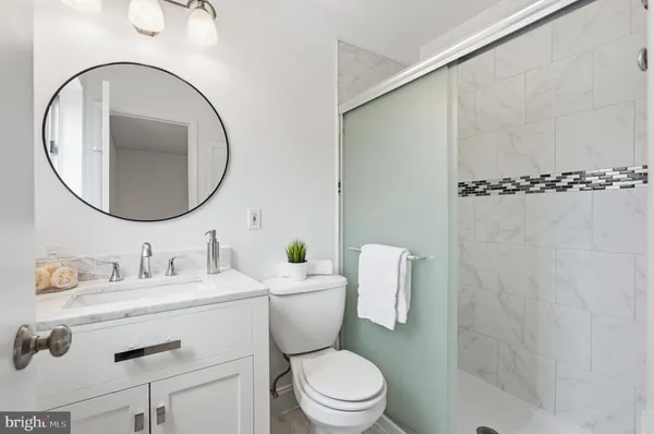 a bathroom with a toilet a sink and a mirror