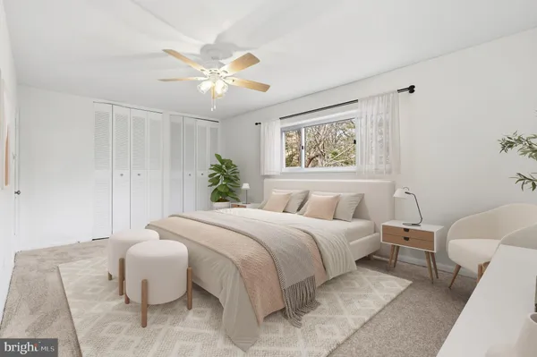 a bedroom with a large bed and a chandelier
