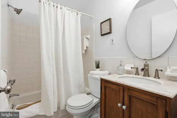 a bathroom with a toilet a sink and a mirror