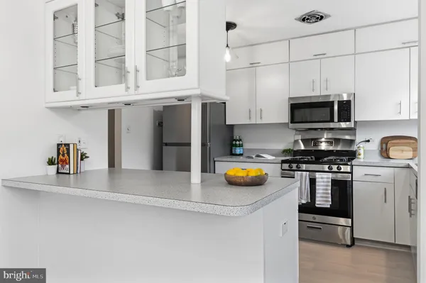 a kitchen with stainless steel appliances a stove a microwave and refrigerator