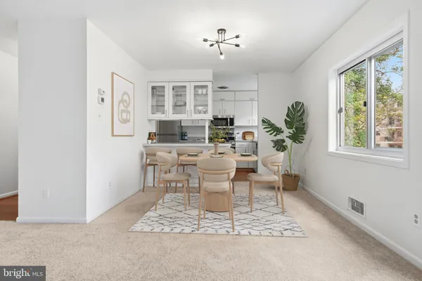a living room with furniture a window and a potted plant