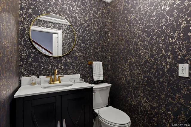 a bathroom with a toilet sink and mirror