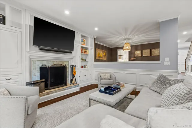 a living room with furniture a fireplace and a flat screen tv