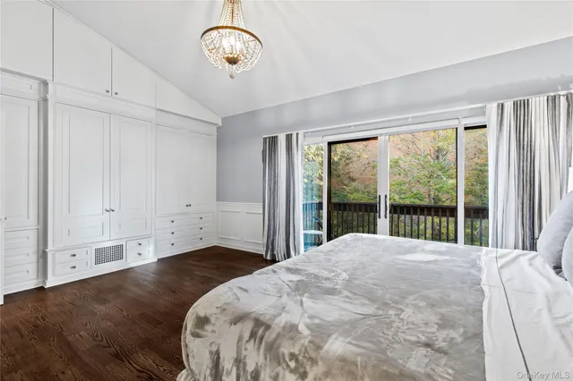 a large bed sitting in a bedroom next to a window