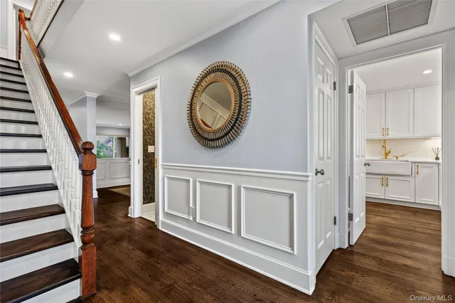 a view of a hallway with entryway wooden floor and front door