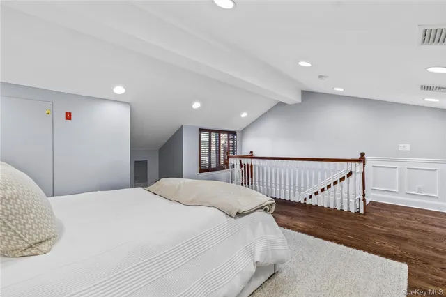 a bed room with a bed and a large window