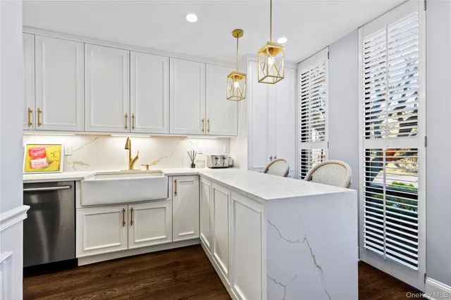a kitchen with a sink window and cabinets