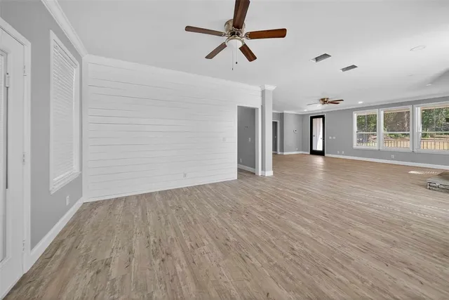 wooden floor in an empty room with a window