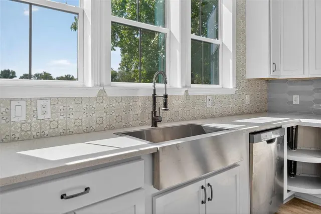 a spacious bathroom with a granite countertop sink and a large mirror
