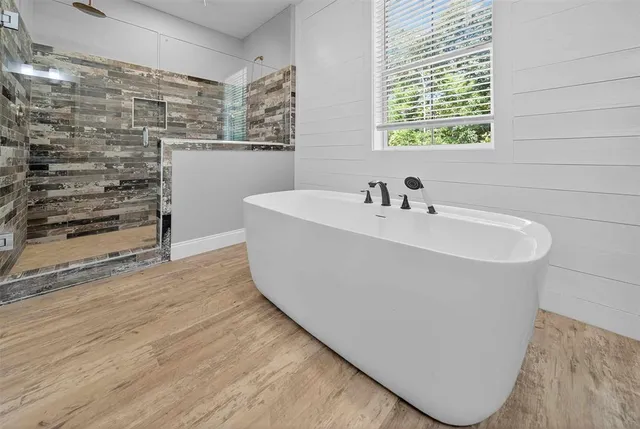 a open kitchen with a white cabinets and wooden floor
