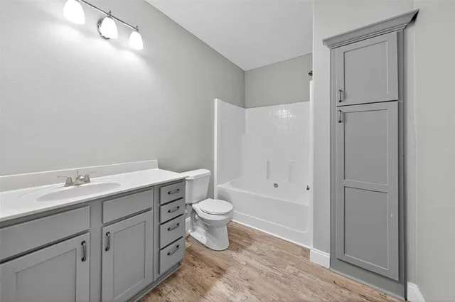 an empty room with closet and fan