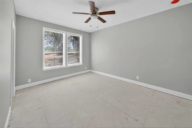 an empty room with closet and windows