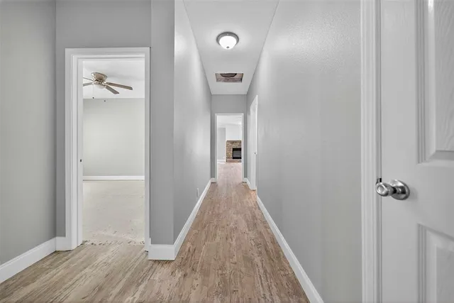 a kitchen with white cabinets and sink