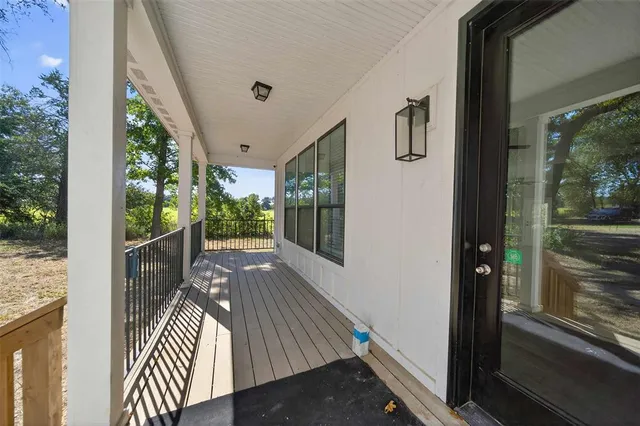 a view of balcony with wooden floor