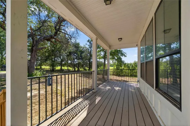 a view of a porch with wooden floor and outdoor space