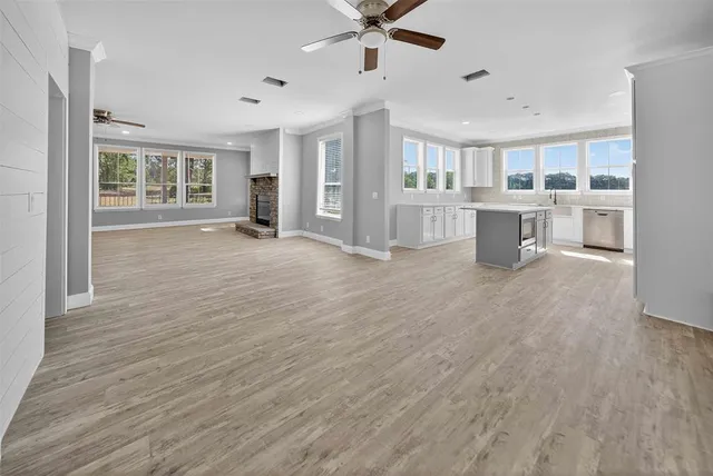 a view of a livingroom with furniture and a kitchen