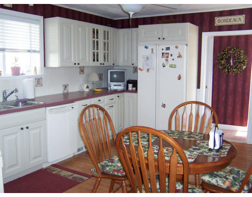41 Baker Road Everett, MA 02149 - Photo 7 of 9 a kitchen with stainless steel appliances granite countertop a refrigerator a stove a sink dishwasher and a dining table with wooden cabinet