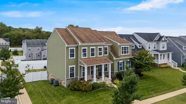 a aerial view of a house next to a yard
