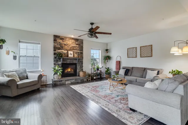 a living room with furniture a rug and a flat screen tv