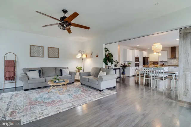 a bedroom with a bed a desk and chair with window
