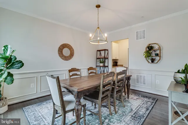 a view of a dining room and hall with furniture