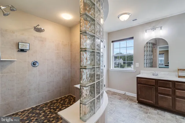 a view of walk in closet with clothes